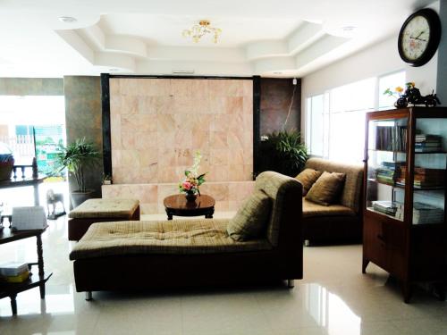 a living room with a couch and a table at Euro Boutique Hotel in Chumphon
