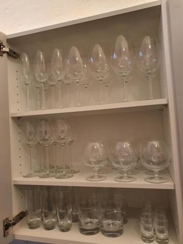 a cupboard filled with lots of empty wine glasses at Le Bijou BK9 Presidential Suite in Bern