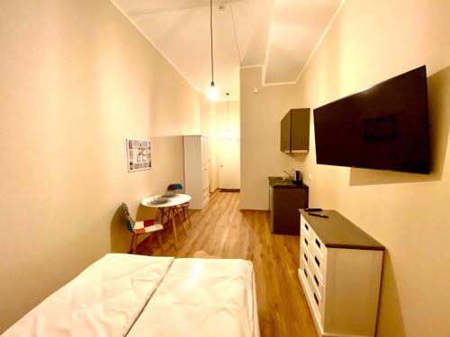 a hospital room with a bed and a flat screen tv at Kastanimaja Apartments in Tartu