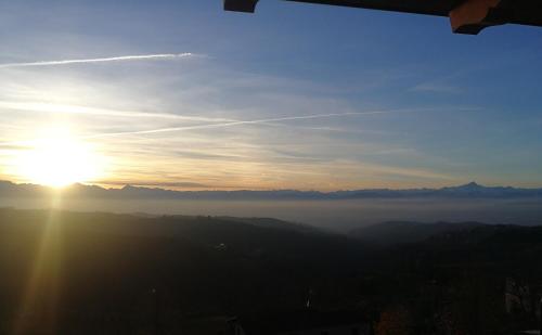 a view of the sun rising over a foggy valley at Villa Belvedere Langhe in Belvedere Langhe