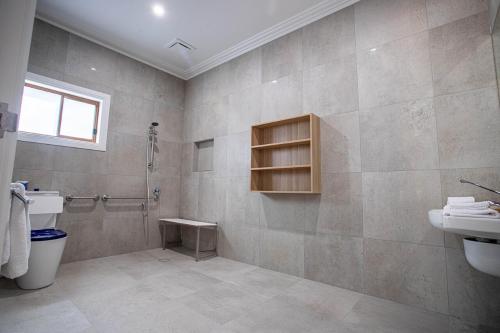 a bathroom with a shower and a toilet and a sink at Red Waratah Accommodation in Bendigo