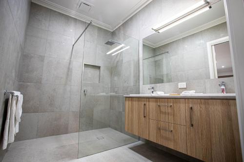 a bathroom with a shower and a sink at Red Waratah Accommodation in Bendigo