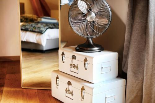 a fan sitting on top of a stack of drawers at Maison d'hôtes & SPA La Scierie in Salins-les-Bains