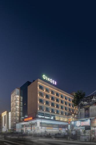 a hotel building with a sign on top of it at Ginger Surat City Centre in Surat