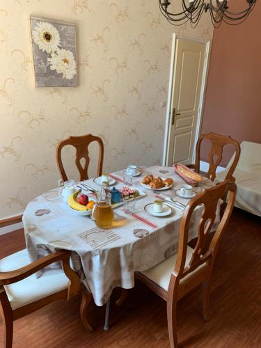 a dining room table with food on top of it at Le Pontet in Miramont-de-Guyenne