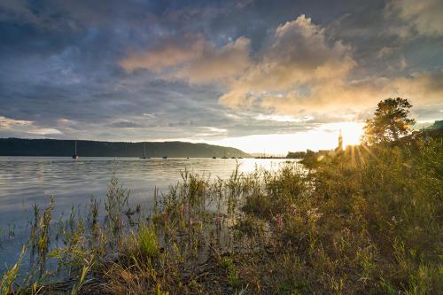 a view of a body of water with the sun setting at Hotel Landhaus Sternen in Sipplingen