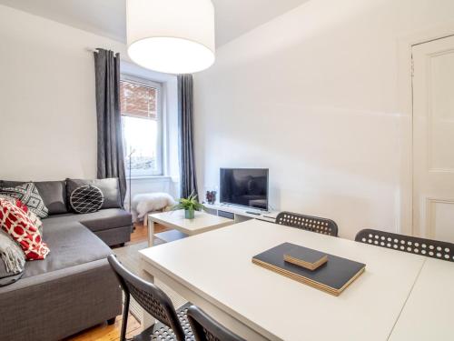 a living room with a couch and a table at Stylish & Charming Retreat for 2- City Centre! - Pass the Keys in Edinburgh