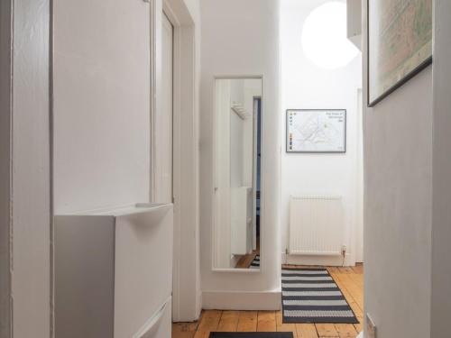 um corredor com paredes brancas e um espelho em Stylish & Charming Retreat for 2- City Centre! em Edimburgo