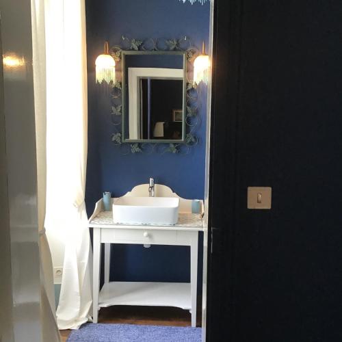 a bathroom with a sink and a mirror at Maison de la Comtesse in Cosne-dʼAllier