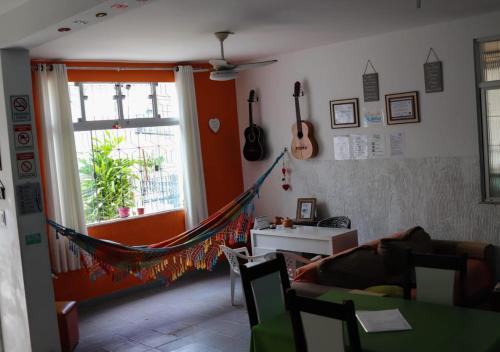 a living room with a hammock in a room at Casa de Mainha Friendly Hostel in Salvador