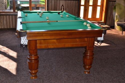 a green pool table with balls on top of it at Synevyrskyj Chardash in Synevyr