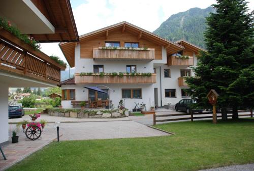 a building with two balconies on the side of it at Haus Kargruber in Santa Maddalena in Casies
