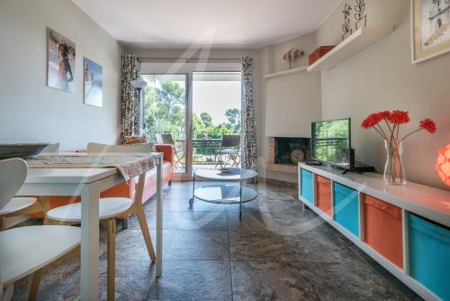 a kitchen with colorful cabinets and a dining room at Estrella by SeaMount Rentals in Calella de Palafrugell