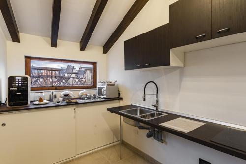 a kitchen with a sink and a counter top at Etnaglossa in Linguaglossa
