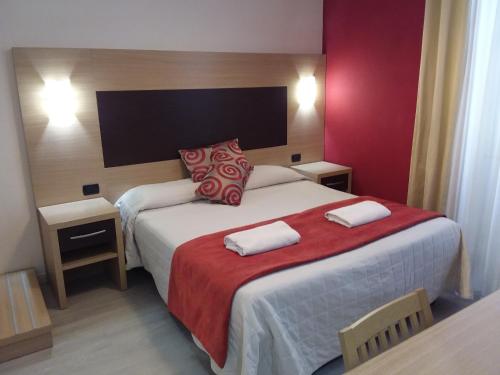 a hotel room with a bed with two towels on it at Hotel Playa in Viareggio