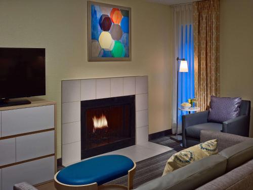 a living room with a couch and a fireplace at Sonesta ES Suites Providence - Airport in Warwick