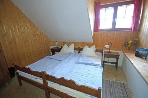 a bedroom with a large bed in a attic at Straniger Alm in Stranig
