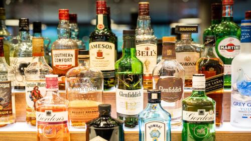 a bunch of bottles of alcohol on a table at Holiday Inn London Luton Airport by IHG in Luton