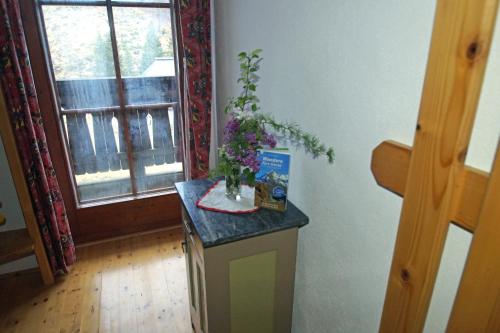 a room with a counter with a vase of flowers on it at Straniger Alm in Stranig