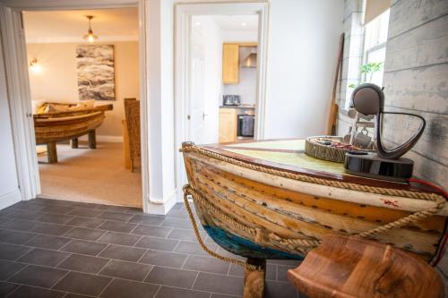 an old wooden boat sitting in a room with a hallway at The Beach House in Eastbourne