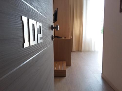 a room with a wooden door with a window at Hotel Playa in Viareggio