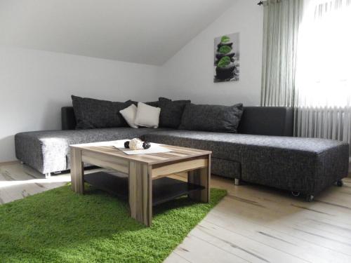 a living room with a couch and a table at Landhaus Daum in Schwendau