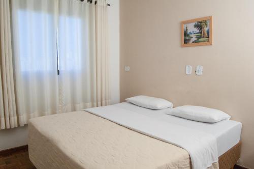 Säng eller sängar i ett rum på Hotel Londri Star