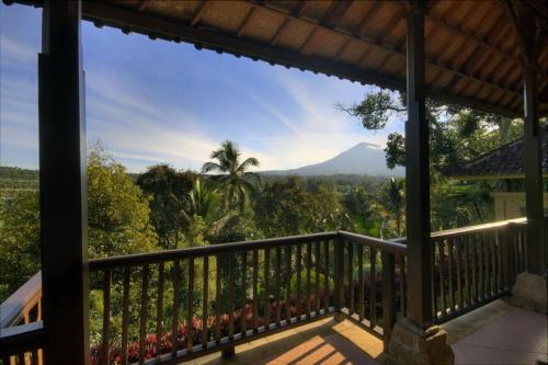 a balcony with a view of a mountain at Cempaka Belimbing Villa in Blimbing