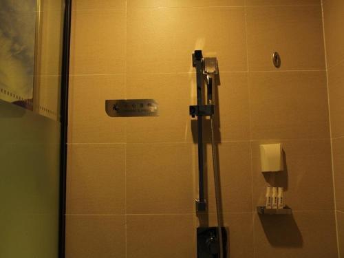 a shower with a glass door in a bathroom at Lavande Hotel Yinchuan Railway Station Wanda in Yinchuan