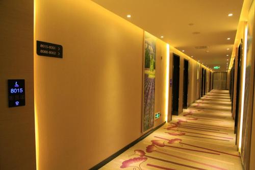 a hallway in a hotel with a sign on the wall at Lavande Hotel Tianshui Gangu Jicheng Square in Tianshui