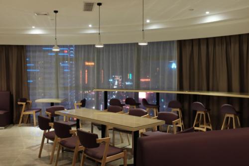 a conference room with a table and chairs in a building at Lavande Hotel Dongguan Humen Wanda Square in Dongguan