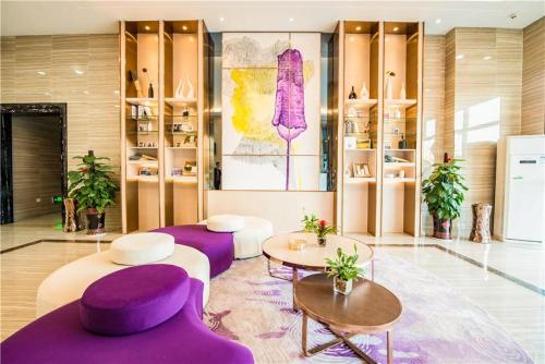 a room with purple chairs and tables in a store at Lavande Hotel Luzhou BBQ new World in Luzhou