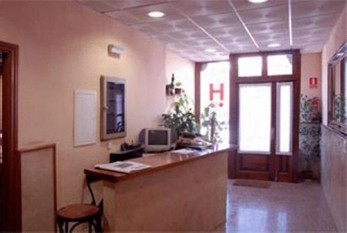an office with a desk with a computer on it at Hotel Laberinto in Sigüenza