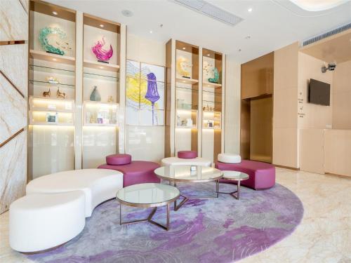 a room with pink and white furniture and shelves at Lavande Hotel Zhongshan Tanzhou in Zhongshan