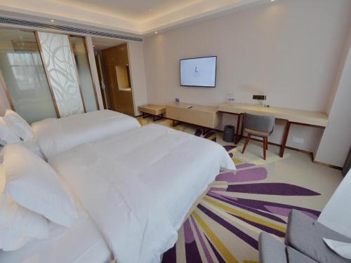 Ένα ή περισσότερα κρεβάτια σε δωμάτιο στο Lavande Hotel Xingyi Jushan Avenue
