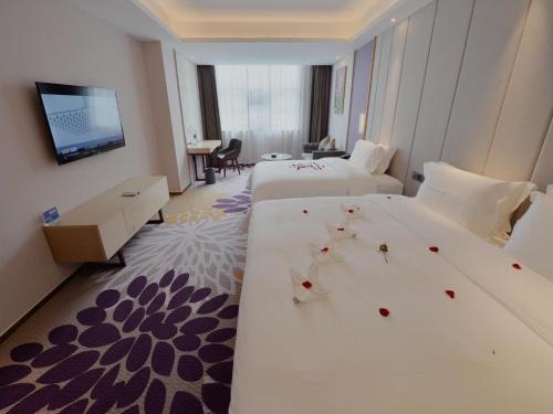 Gulta vai gultas numurā naktsmītnē Lavande Hotel Xingyi Jushan Avenue