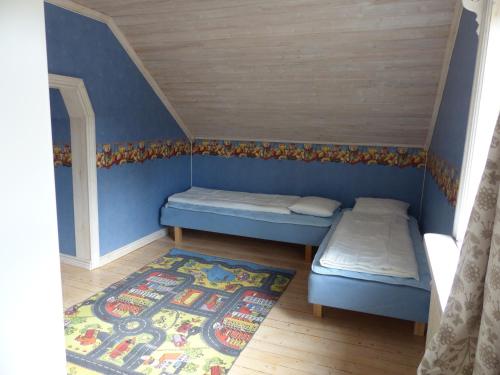 a small room with two beds and a rug at Ferienhaus Björkebo in Stöllet