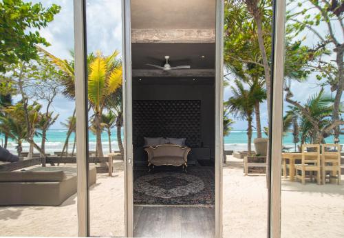 a room with a view of the beach and the ocean at Casa Malca in Tulum