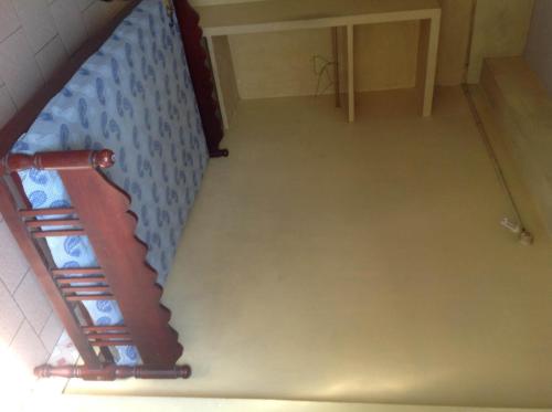 an overhead view of an empty room with a ladder at St. Antonys Lodge in Cochin
