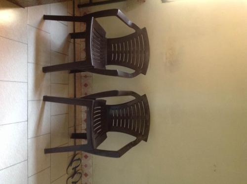 two black shelves hanging on a wall at St. Antonys Lodge in Cochin