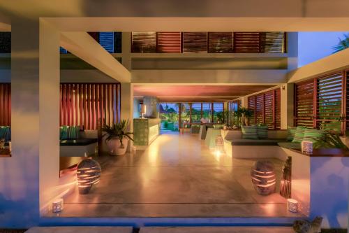 a lobby of a villa with lights on at Hotel Komune and Beach Club Bali in Keramas