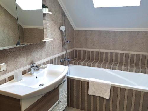 a bathroom with a sink and a bath tub at Apartment Sweethome 3 FREE PARKING in Uzhhorod