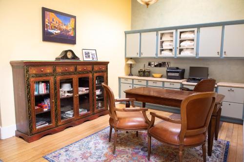 a dining room with a table and chairs and a cabinet at Letson Loft Hotel in Bisbee