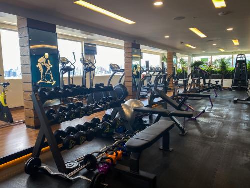a gym with a lot of treadmills and machines at Mercure Alameda Quito in Quito
