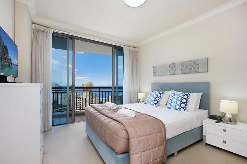 a bedroom with a bed and a large window at Chevron Renaissance managed by Gchs in Gold Coast