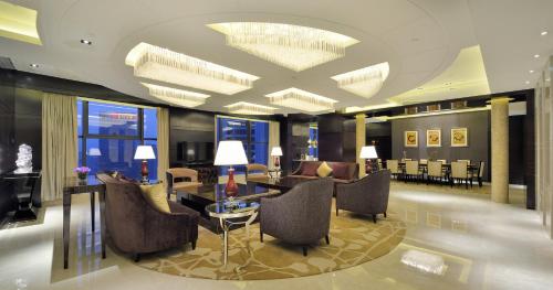 a lobby with chairs and a table in a building at Kempinski Hotel Taiyuan in Taiyuan