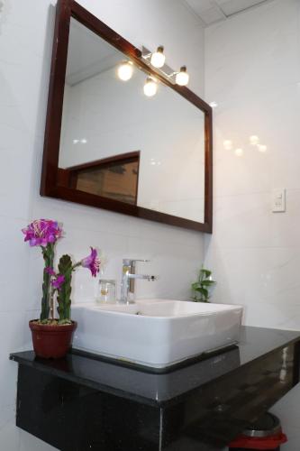 y baño con lavabo blanco y espejo. en Hồng Hạc Hotel en Tuy Hoa