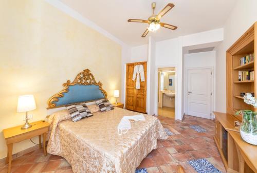 a bedroom with a bed and a ceiling fan at Villa Lieta in Ischia