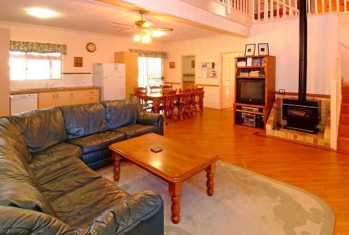 a living room with a couch and a coffee table at Rosewood Cottage in Dunsborough