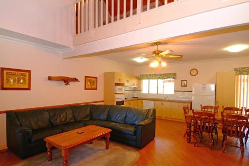 a living room with a couch and a table at Rosewood Cottage in Dunsborough